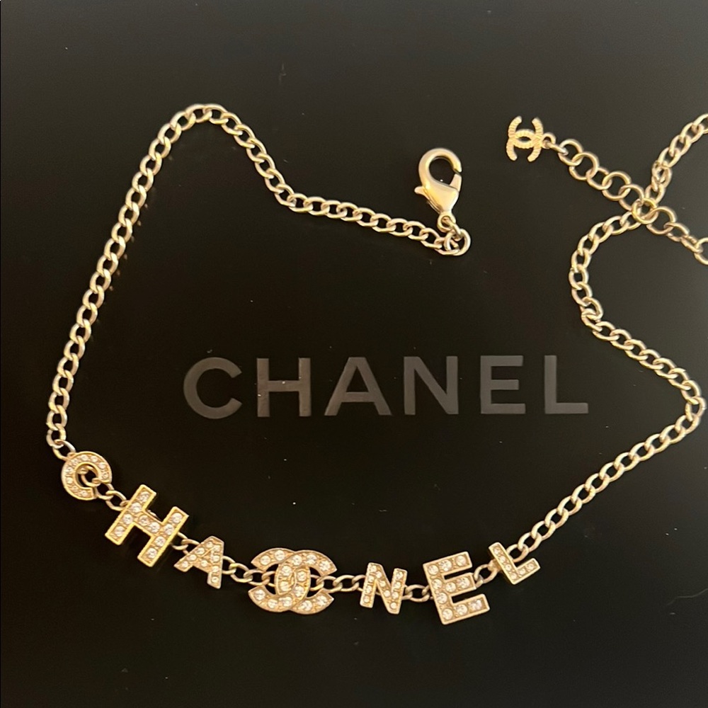 CHANEL Gold Necklace Spelled out Chanel with CC logo in Crystal